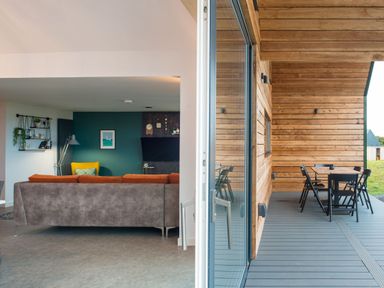 A living room with a sofa and view of a deck at The Irvine in North Berwick