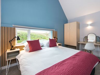 A bedroom with a bed, desk and window at The Irvine in North Berwick
