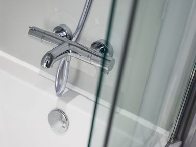 A shower faucet with a hose in a bathroom at The Irvine in North Berwick