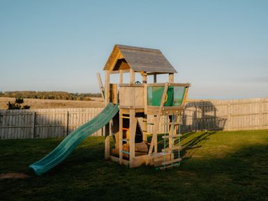 A playhouse with a slide in a garden at The Irvine in North Berwick