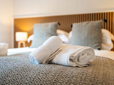 A bedroom with bed and towels at The Townsend in North Berwick