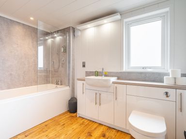A bathroom with a bathtub, shower, sink, and toilet at The Townsend in North Berwick