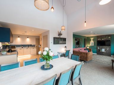 A kitchen and living area with a table and chairs at The Laidlaw Spa North Berwick