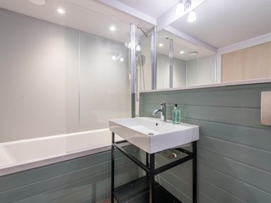 A bathroom with a bathtub and sink at The Laidlaw Spa North Berwick