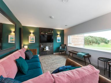 A living room with a sofa and television at The Laidlaw in North Berwick