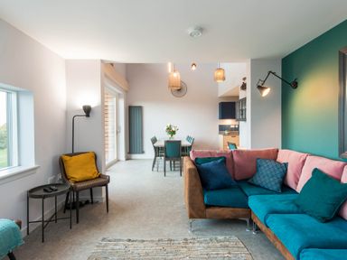 A living room with a sofa and dining area at The Laidlaw in North Berwick