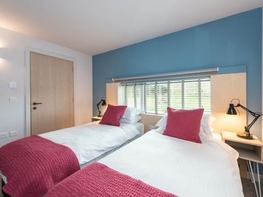 A bedroom with two single beds and a window at The Laidlaw in North Berwick