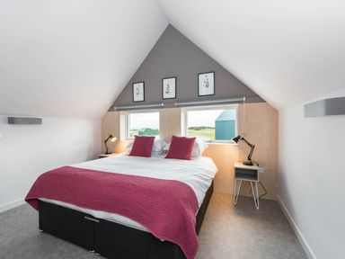 A bedroom with a bed and bedside tables at The Laidlaw in North Berwick
