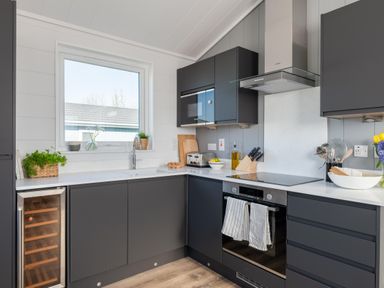 A kitchen with a window and modern appliances at Kynance Spa in Bude