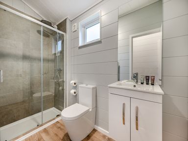 A bathroom with a shower and toilet at Kynance Spa in Bude