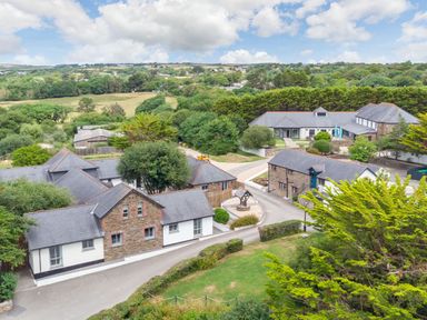 An outdoor area with multiple houses and landscaping at Kynance Spa in Bude