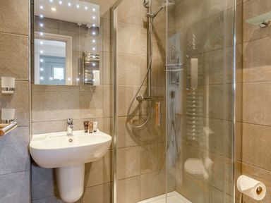 A bathroom with a shower and sink at Summerleaze Garden Cottage 3 Spa Bude