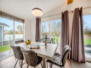 A dining room with a table and chairs at Mullion Spa in Bude
