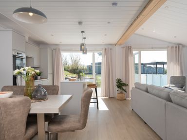A living room with a table and chairs at Sennen 3 Spa Roof Terrace (Pet) Bude