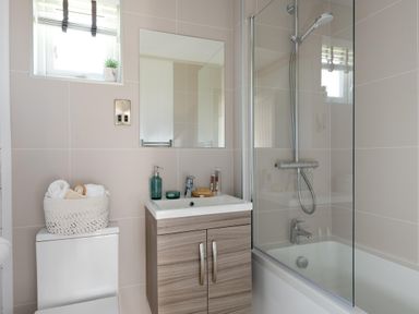 A bathroom with a shower and sink at Sennen 3 Spa Roof Terrace (Pet) Bude