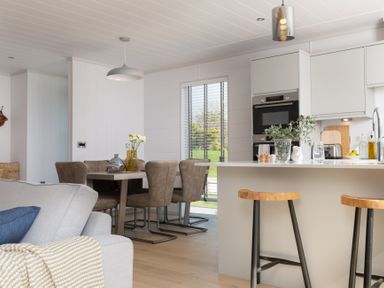 A kitchen with a table and chairs at Sennen 3 Spa Roof Terrace Bude
