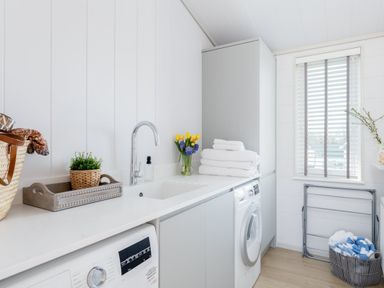 A laundry room with a washing machine and sink at Sennen 3 Spa Roof Terrace, Bude