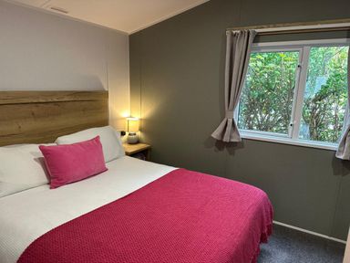 A bedroom with a bed and lamp at Willerby Ellerrton (delyn) Prestatyn