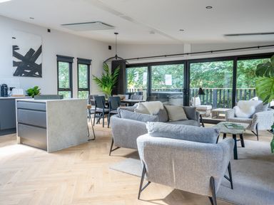 A living room with a sofa and dining area at Cabin 2.0 Deluxe Dumfries
