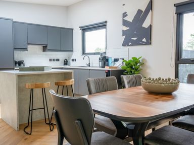 A kitchen with a table and chairs at Cabin 2.0 Deluxe in Dumfries