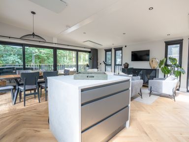 A living room with a kitchen island and dining area at Cabin 2.0 Deluxe in Dumfries