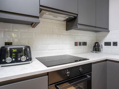 A kitchen with a toaster kettle and cooktop at Cabin 2.0 Deluxe in Dumfries
