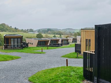 A view of multiple cabins with a gravel path in an outdoor area at Cabin 2.0 Deluxe in Dumfries