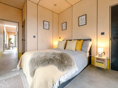 A bedroom with a bed, lamp, and wall art at Orka Duo 2.0 (Pet) Dumfries