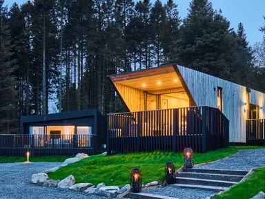 A house with a deck and steps surrounded by trees at Orka Duo 2.0 (Pet) Dumfries