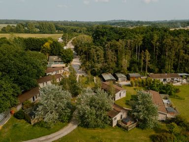An aerial view of buildings surrounded by trees and fields at Spitfire Lodge in Fair Oak