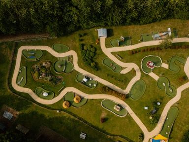 A mini golf course with pathways and green areas at Spitfire Lodge in Fair Oak