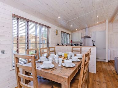 A dining area with a table set for breakfast at Lancaster Lodge in Fair Oak
