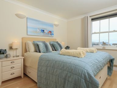 A bedroom with a bed and lamps at 8 Thurlestone Beach in Kingsbridge