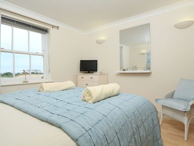 A bedroom with a bed and television at 8 Thurlestone Beach in Kingsbridge