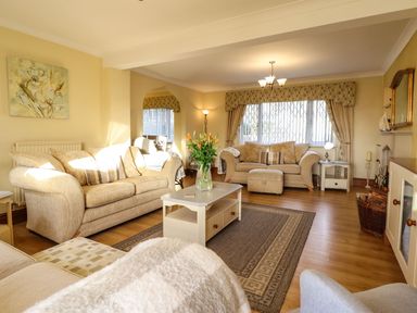 A living room with sofas and a coffee table at Llwyn Derw in Talybont