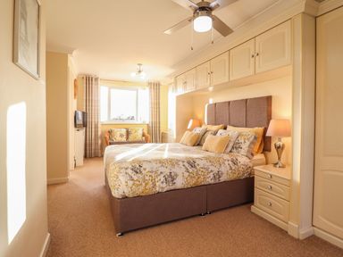 A bedroom with a bed and bedside tables at Llwyn Derw in Talybont