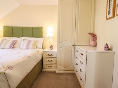 A bedroom with a bed and furniture at Llwyn Derw in Talybont