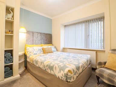 A bedroom with a bed and shelves at Llwyn Derw in Talybont