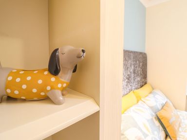 A dog figurine on a shelf in a bedroom at Llwyn Derw, Talybont
