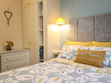 A bedroom with a bed and nightstand at Llwyn Derw in Talybont
