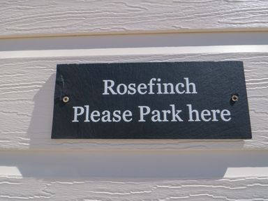 A sign that says Rosefinch Please Park here at Rosefinch Cabin Staintondale near Scarborough