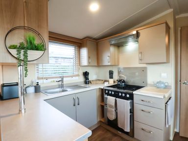 A kitchen with a sink and stove at Swift Cabin Scarborough