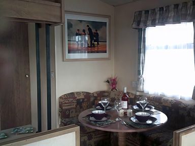A dining area with a table set for meals at Coopers Beach Holiday Park - Holiday Accommodation 3999 Mersea Island