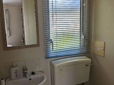 A bathroom with a sink and a toilet at Coopers Beach Holiday Park - Holiday Accommodation 6404, Mersea Island