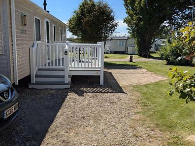 An outdoor area with a deck and car at Coopers Beach Holiday Park - Holiday Accommodation 6404 Mersea Island
