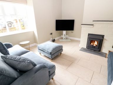 A living room with a sofa and television at The Old Bakery in Banbury