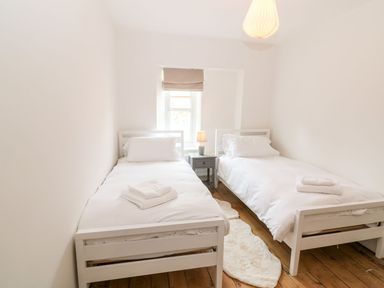 A bedroom with two beds and a window at The Old Bakery in Banbury
