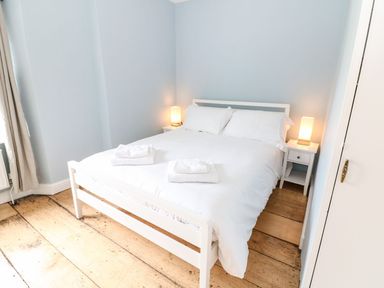 A bedroom with a bed and nightstand at The Old Bakery in Banbury