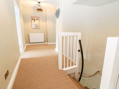 A hallway with a staircase and radiator at The Old Bakery in Banbury