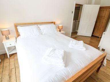 A bedroom with a bed and nightstand at The Old Bakery in Banbury